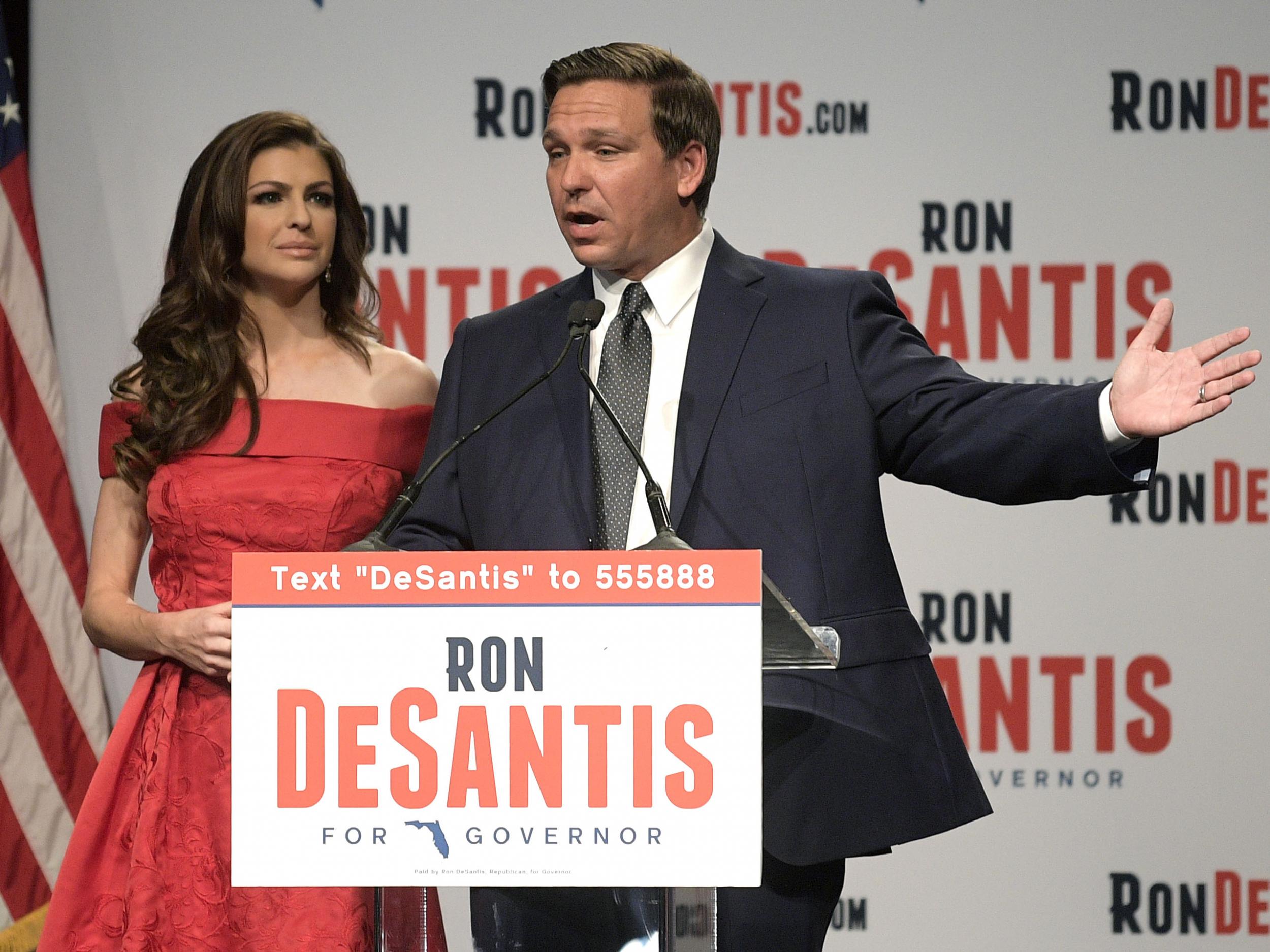 El candidato republicano a gobernador de Florida, Ron DeSantis, a la derecha, habla a sus partidarios con su esposa, Casey, en un partido electoral después de ganar las primarias republicanas.